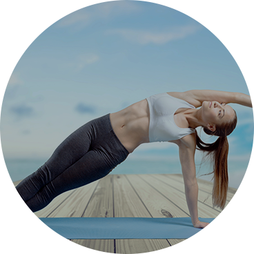 Yoga girl stretching to her left with left hand on yoga mat outside her clean home