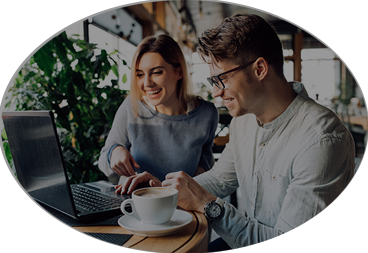 Oval photo of a man and a woman looking at a laptop and smiling about how ADA compliant the site is.