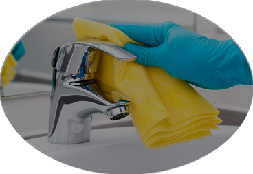 Oval photo of a blue gloved hand cleaning a silver faucet with a yellow cloth - Maid & Cleaning Service Oklahoma City Edmond Moore Yukon